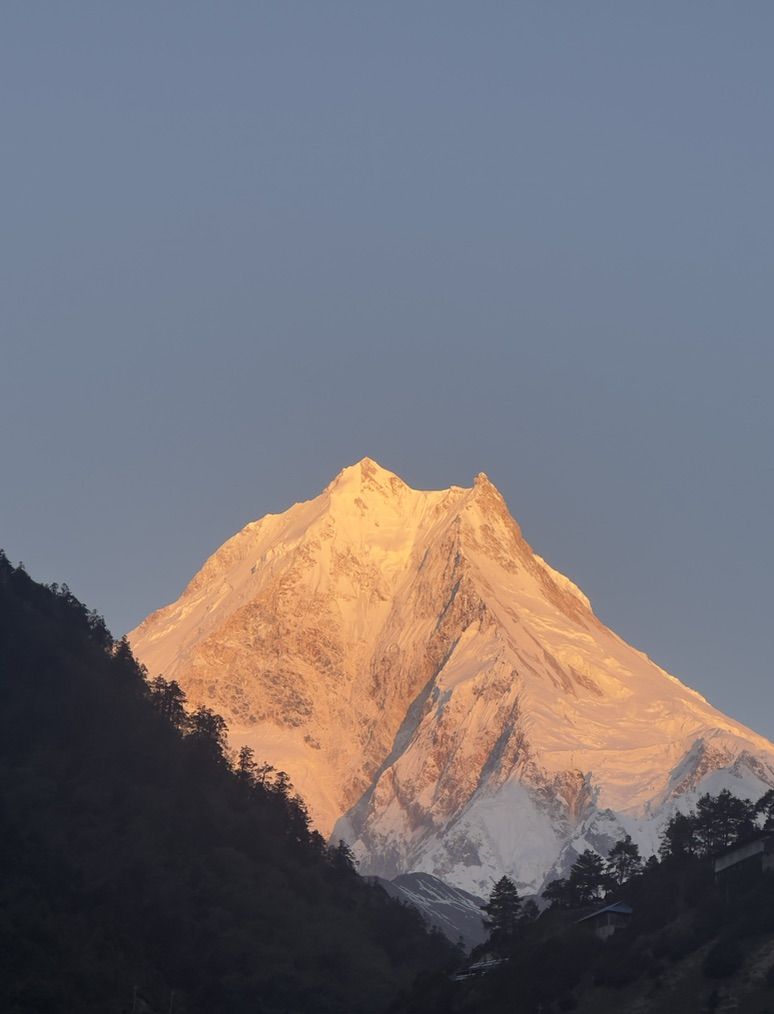 Mt. Manaslu lit orange at sunset